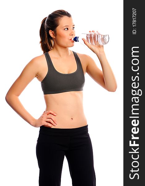 Attractive young woman resting between exercises with water bottle. Attractive young woman resting between exercises with water bottle