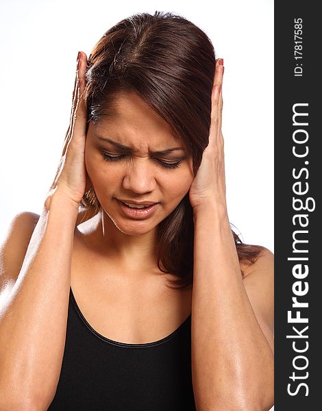 Headshot of beautiful young woman, hands over ears and face showing anguish. Woman indicating she is unhappy, hurt and in a state of disbelief. Headshot of beautiful young woman, hands over ears and face showing anguish. Woman indicating she is unhappy, hurt and in a state of disbelief.