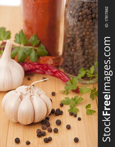 Garlic and pepper with other spices on the kitchen table