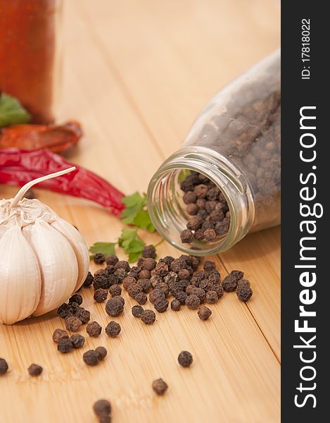 Garlic and pepper with other spices on the kitchen table