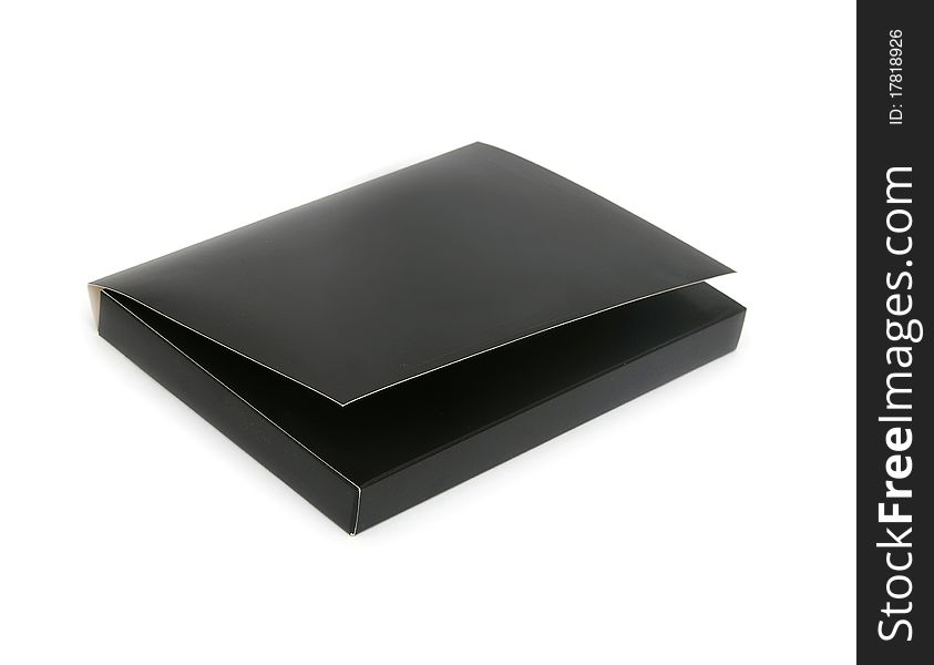 Black cardboard box with the lid off over white background with reflection.