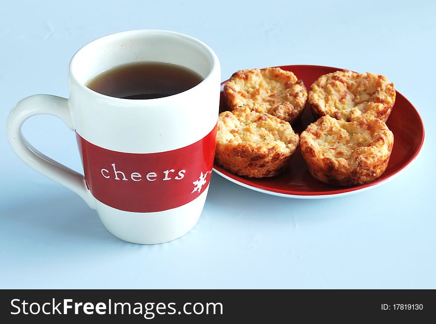Cup of tea with Cheers sign and cheese muffins. Cup of tea with Cheers sign and cheese muffins
