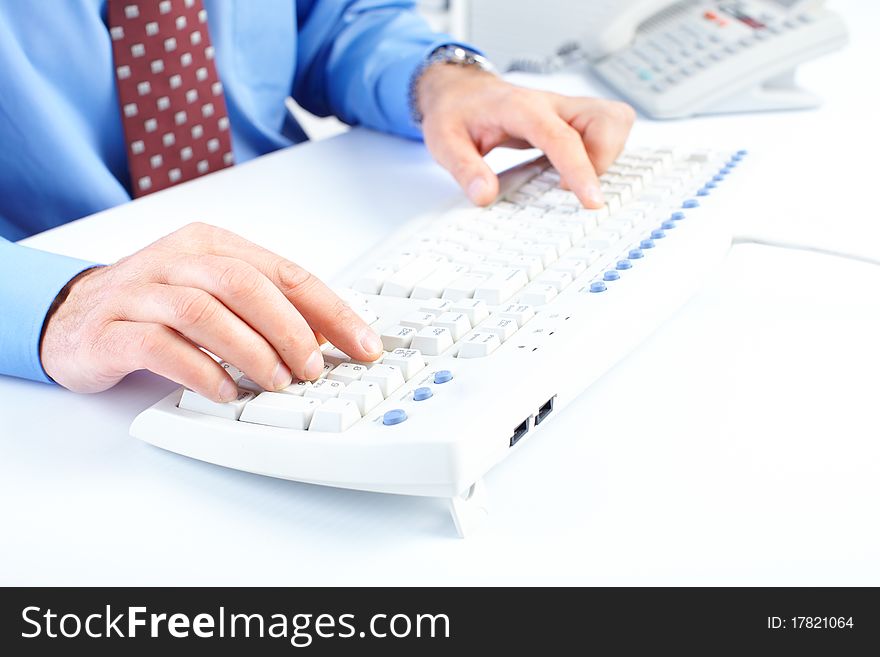 Male hands typing on a white keyboard