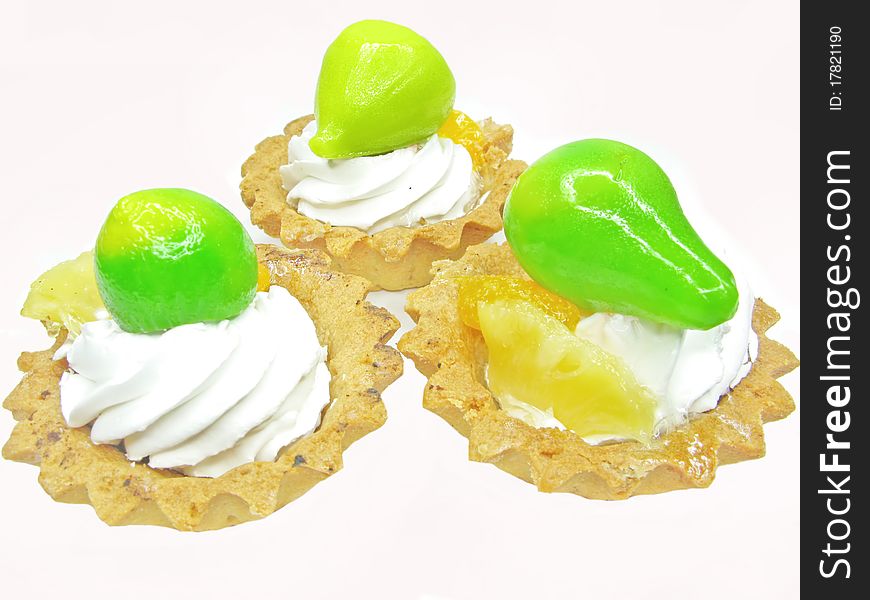 Group of fancy cakes with green marmalade fruits. Group of fancy cakes with green marmalade fruits