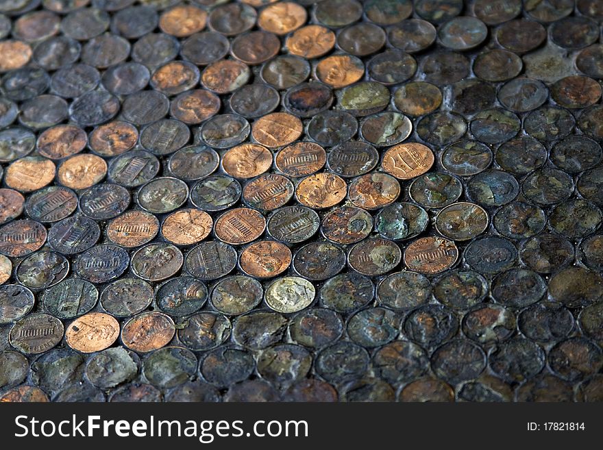 A shot of a floor at a restaurant in California covered in pennies. A shot of a floor at a restaurant in California covered in pennies
