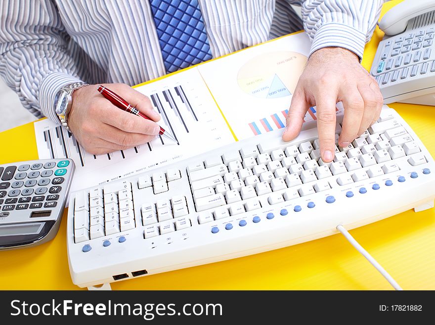 Male hands typing on a white keyboard