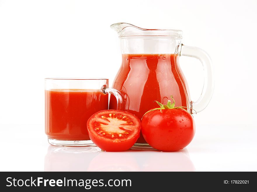 Fresh tomatoes and a glass full of tomato juice. Fresh tomatoes and a glass full of tomato juice