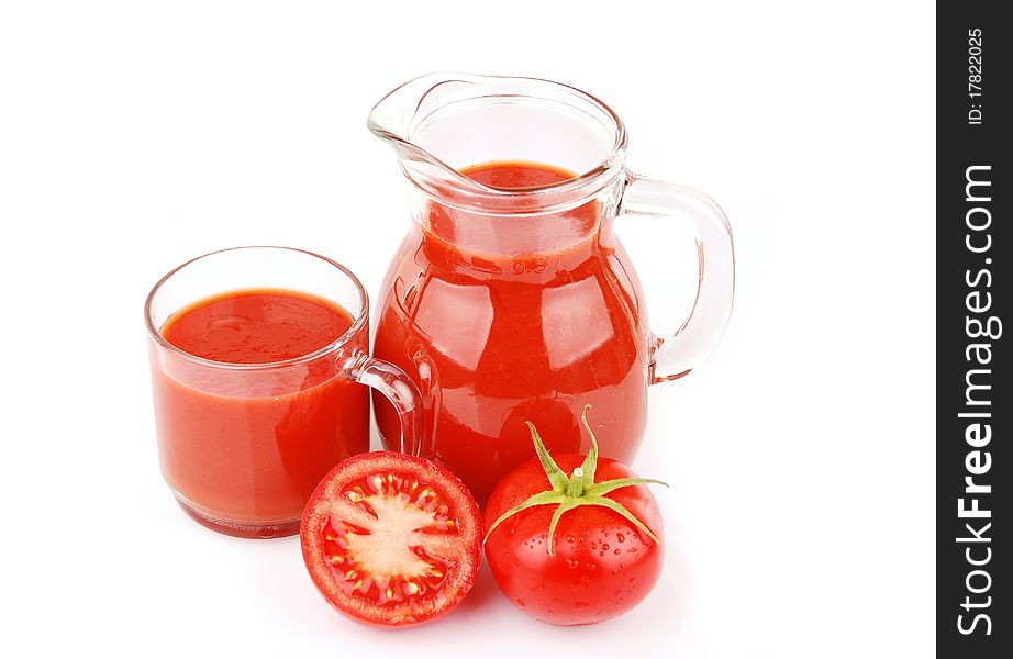 Fresh tomatoes and a glass full of tomato juice. Fresh tomatoes and a glass full of tomato juice