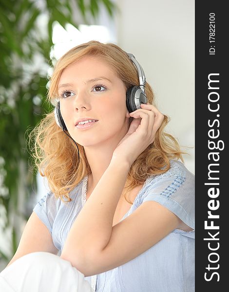 Young fair-haired woman with headphones. Young fair-haired woman with headphones