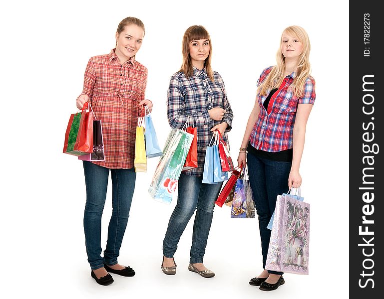 Three girls with colorful shopping bags on white background