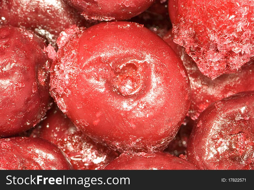 The frozen cherry. Fruit are covered with ice and a snow.