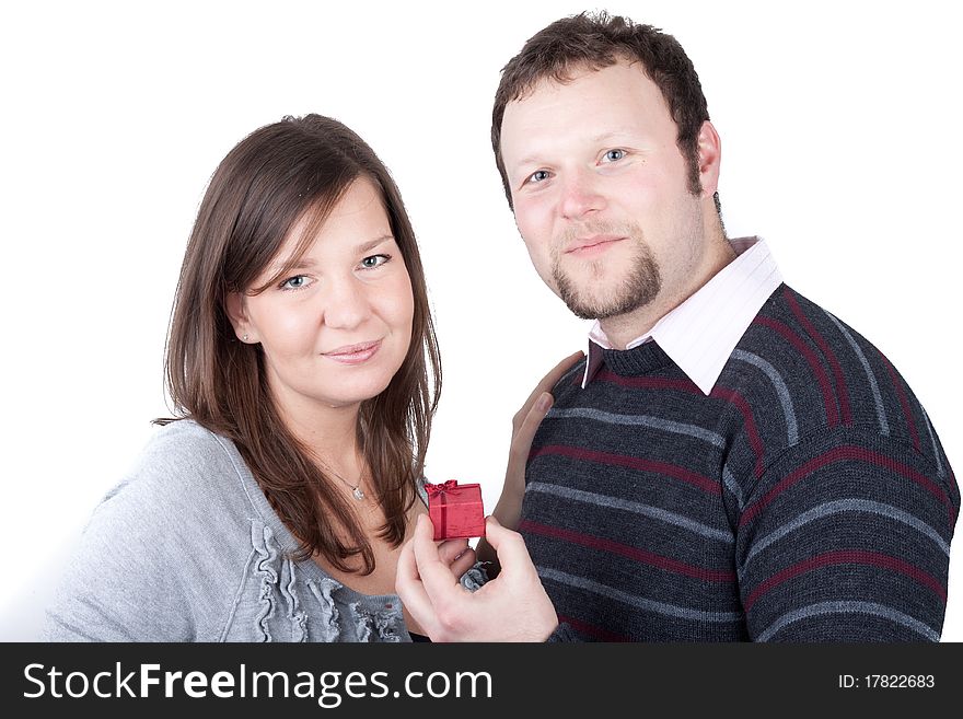 Handsome guy giving a present to his girlfriend isolated over a white background