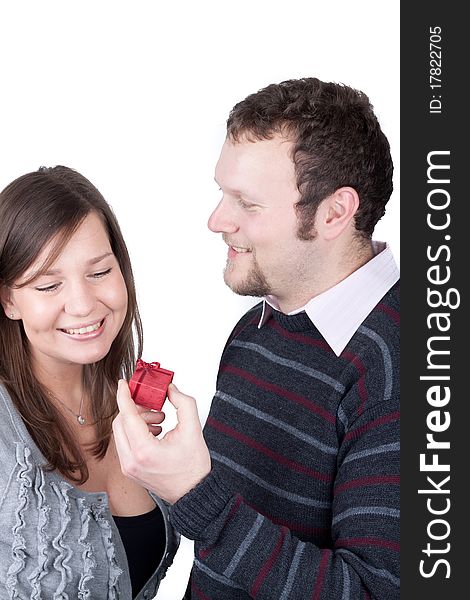 Handsome guy giving a present to his girlfriend isolated over a white background