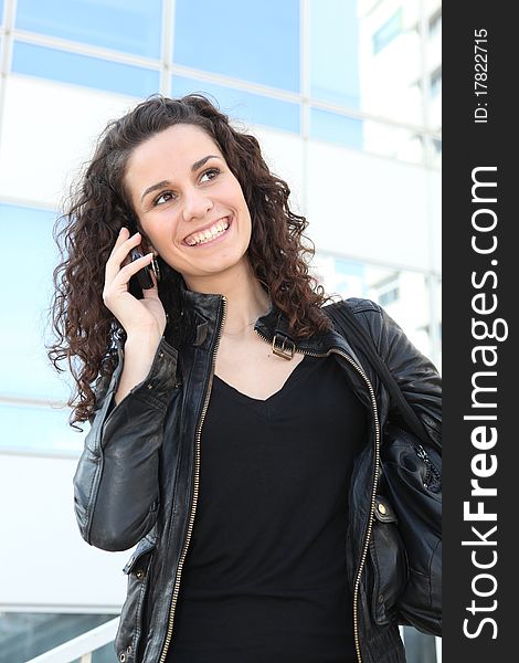 Young woman standing with mobile phone. Young woman standing with mobile phone