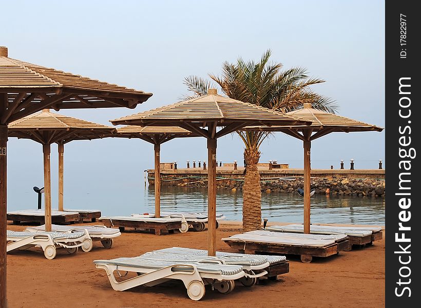 Plank beds on a beach at the sea