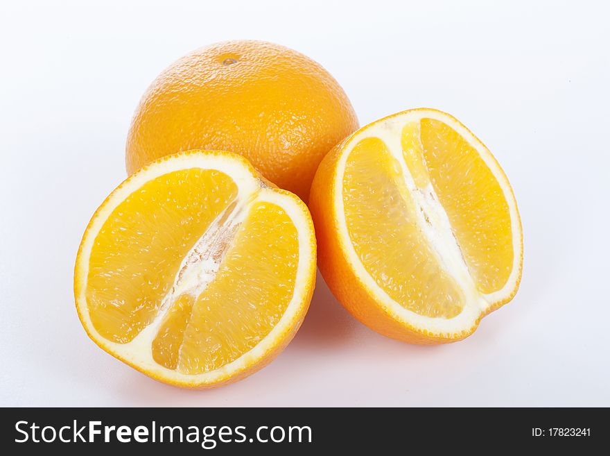 Ripe orange and half on white background. Ripe orange and half on white background