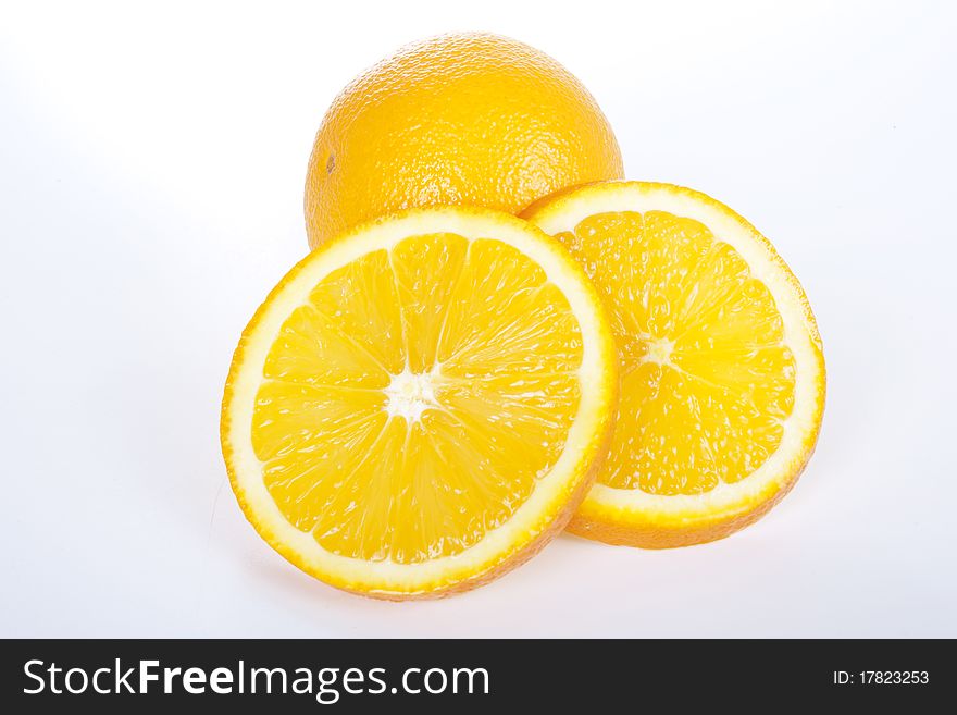 Ripe orange and two slices on white background. Ripe orange and two slices on white background