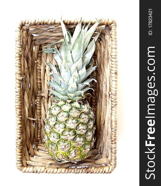 A raw and fresh pineapple in a basket