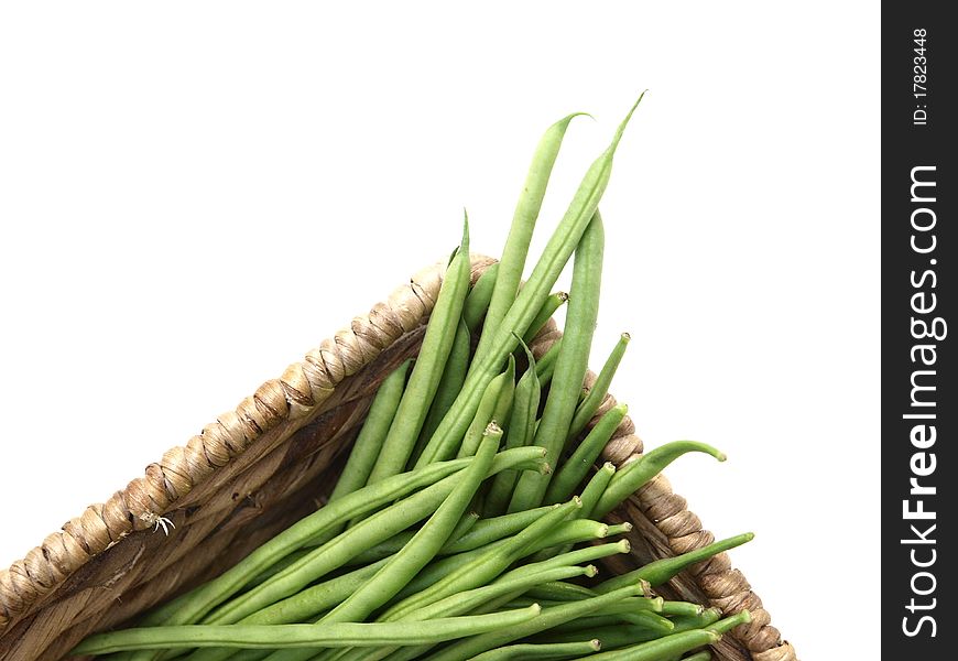 Green beans in a basket on white background