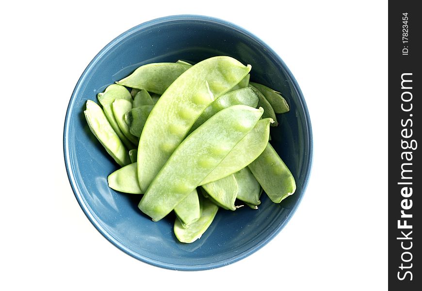 Raw snap peas in a bowl on a white background