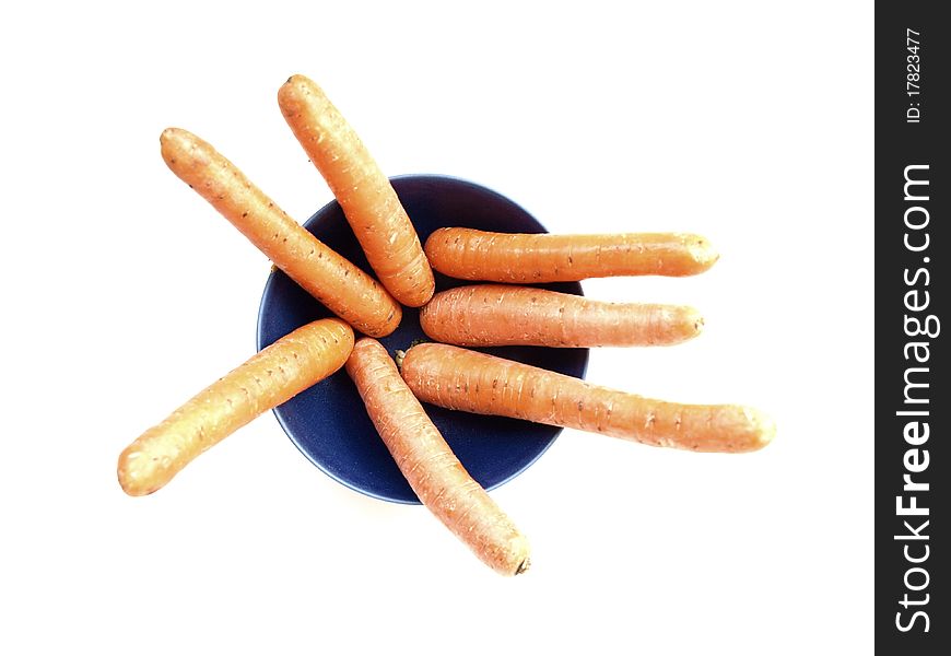 Some carrots in a bowl on a white background
