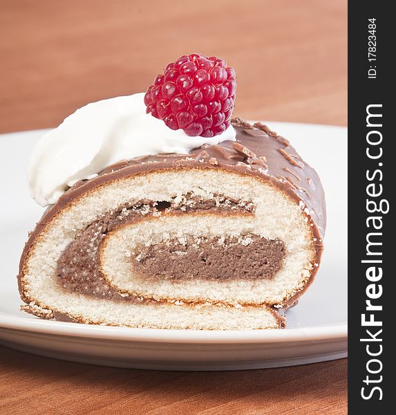 Slice of cake roll 
with cream and raspberry