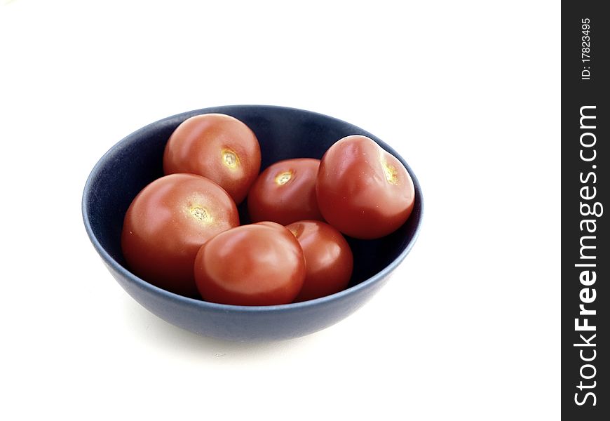 Red tomatoes in a blue bowl