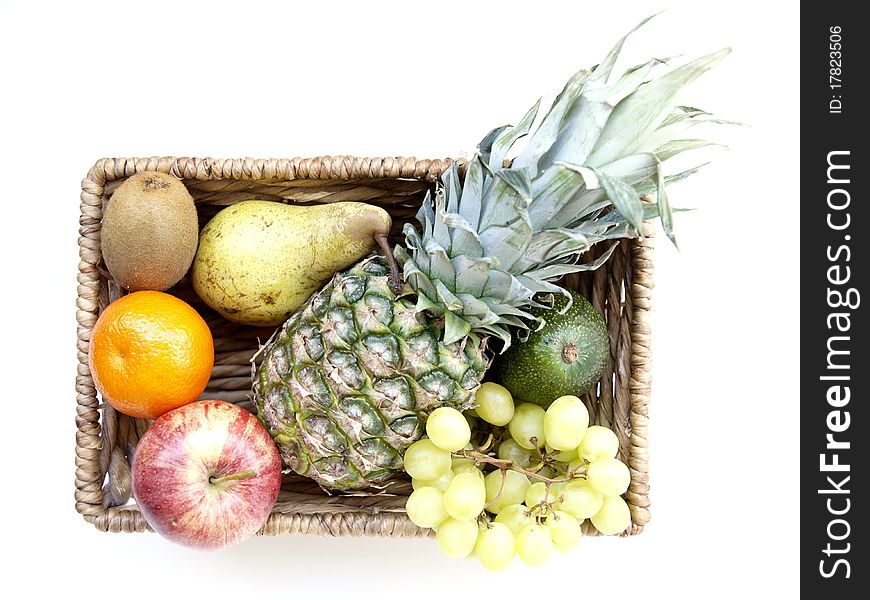 Different fruits in a basket on a white background