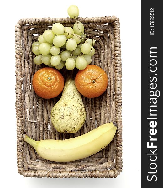 A funny fruit face in a basket
