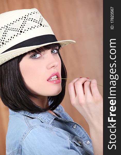 Portrait of a young woman with straw hat