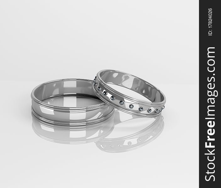 Wedding rings with brilliants on a white background