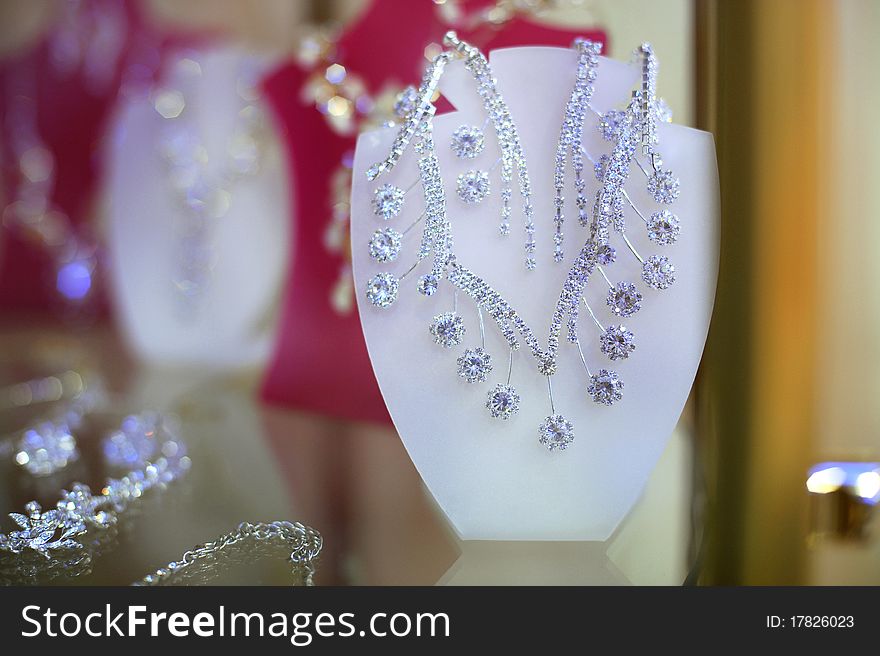 Shiny earrings and necklace at the shopwindow