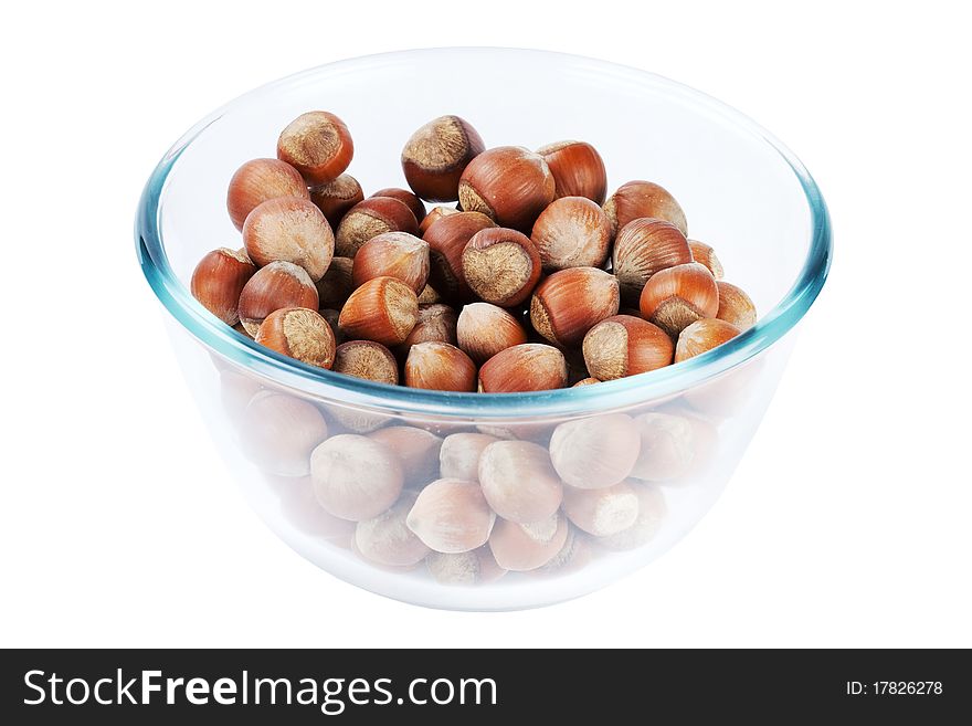 Glass dish with nuts isolated on a white background