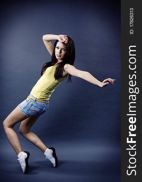 Stylish and cool looking dancer girl on dark background