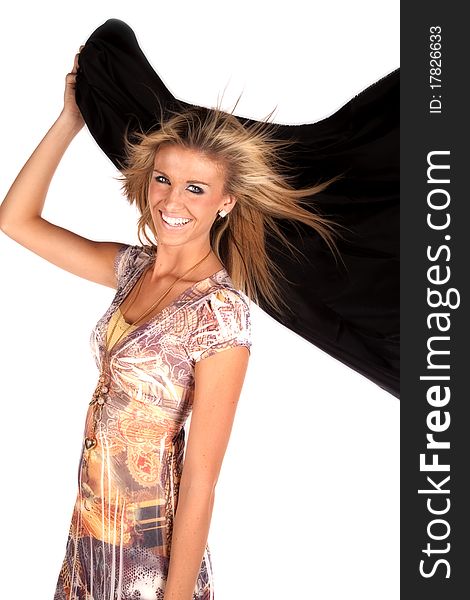 A woman is holding a black blanket blowing in the wind. A woman is holding a black blanket blowing in the wind.