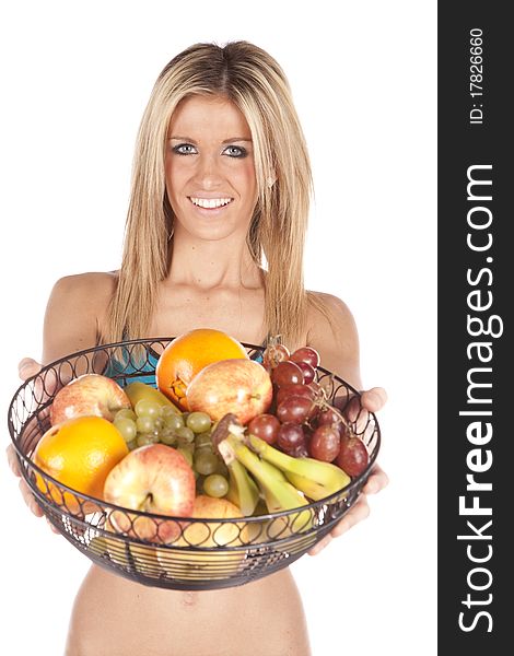 A woman is holding out a basket of fruit. A woman is holding out a basket of fruit.