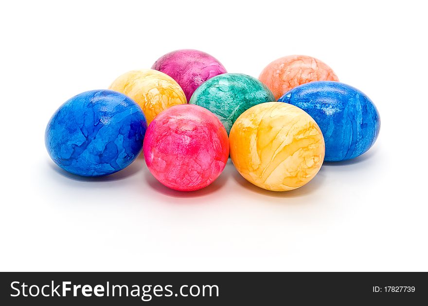 A few colored Easter eggs on a white