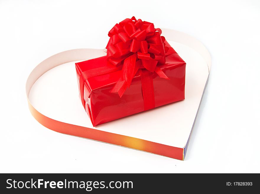 Red gift inside a heart box isolated in white