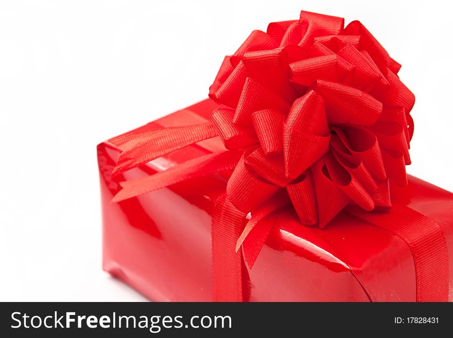 Red gift with big ribbon isolated in white