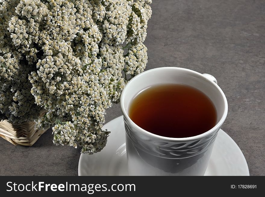 Cup of healing tea and yarrow flowers. Cup of healing tea and yarrow flowers