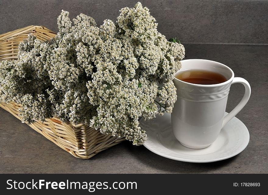 Cup of healing tea and yarrow flowers. Cup of healing tea and yarrow flowers