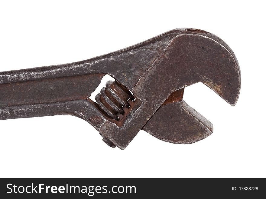 Old, metal adjustable wrench on white background