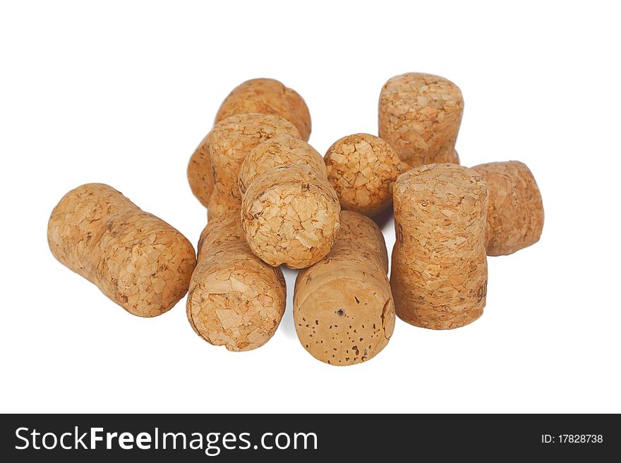 Wine corks lying in disarray on a white background