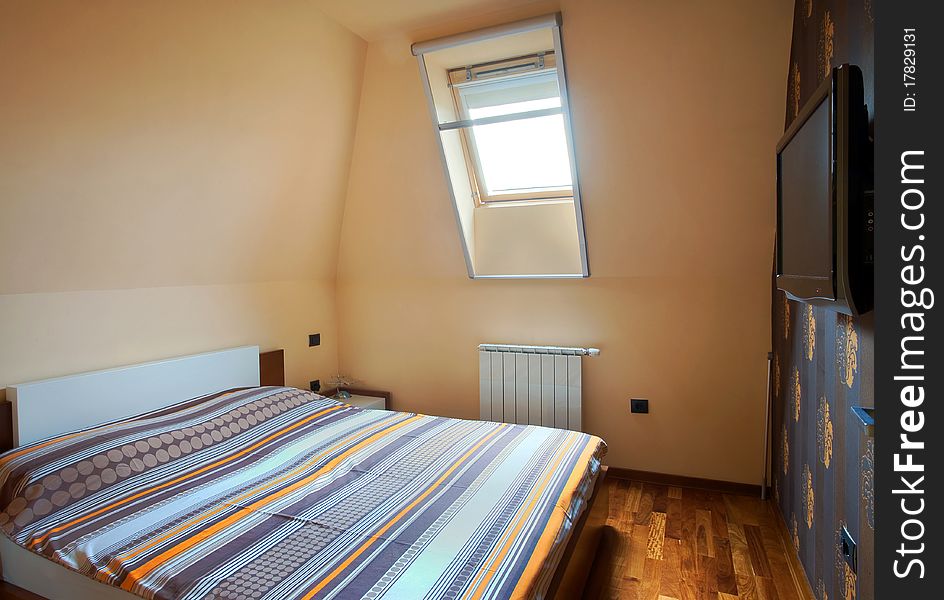 Interior of a bedroom, with modern furniture and light equipment.