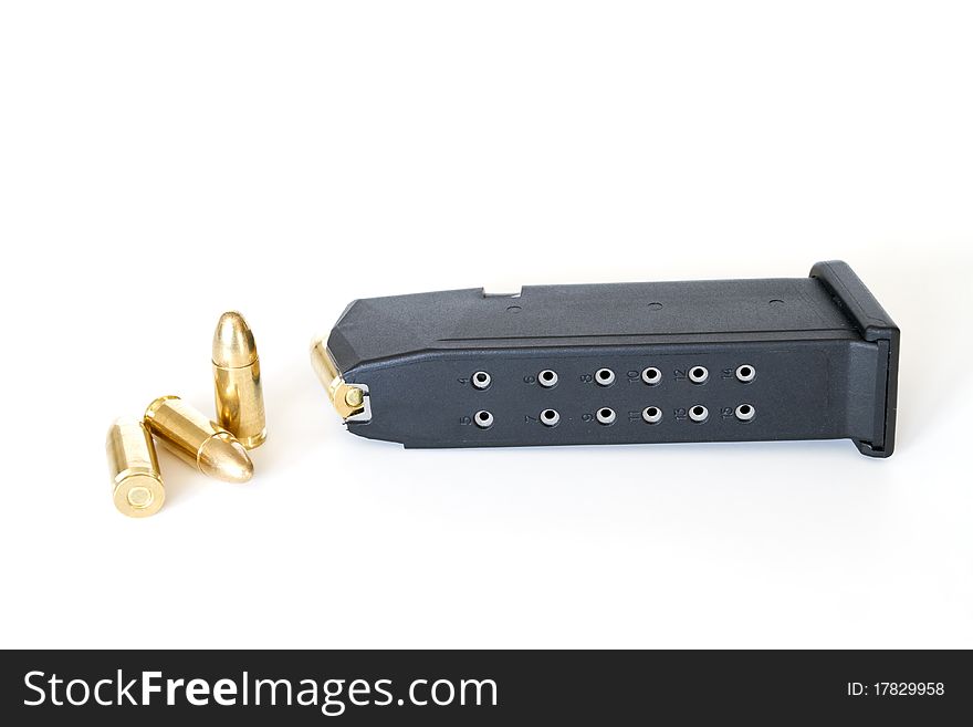 9mm bullets and magazine on white background. 9mm bullets and magazine on white background