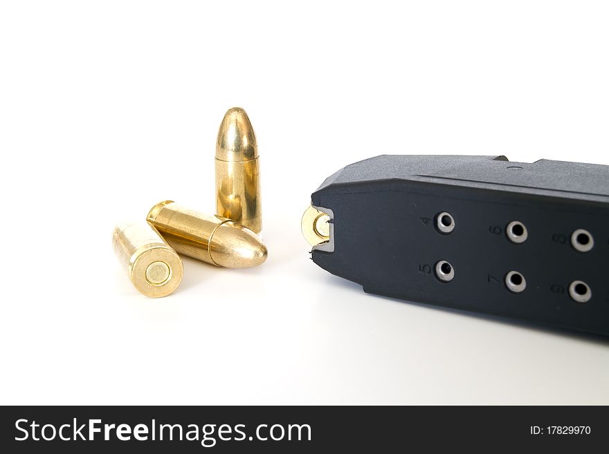 9mm bullets and magazine on white background. 9mm bullets and magazine on white background