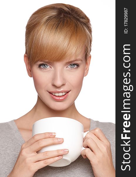 Portrait of a beautiful woman, drinking tea or coffee, isolated on white