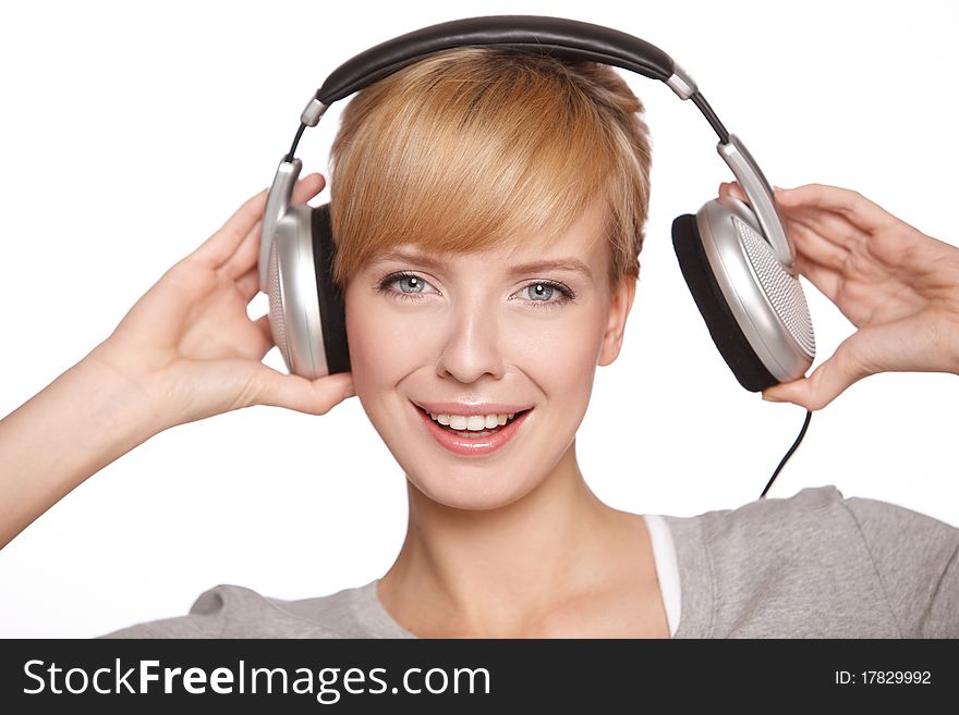 Closeup of a pretty blond female listening to music over headphones. Closeup of a pretty blond female listening to music over headphones