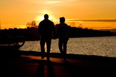 Couple Walking Along Waterfront At Sunset Royalty Free Stock Photo Couple Walking Along Waterfront At Sunset Royalty Free Stock Photo