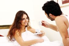 Young Couple Having Breakfast In Bed Royalty Free Stock Images